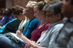 HSU students sitting in auditorium taking notes