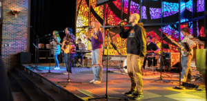 Students singing on stage at Chapel